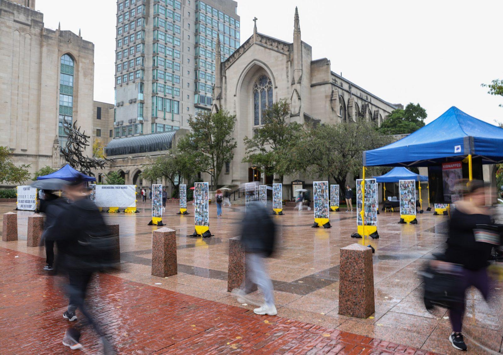 People walk by the BUSI and BU Hillel memorial at Marsh Plaza on Oct. 7. KATE KOTLYAR/DFP PHOTOGRAPHER 