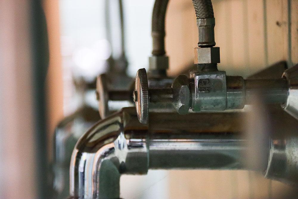 Pipes under a sink. Study abroad students in Dublin, Ireland through BU Global Programs reported “green” water in their residence hall, followed by 90 hours without hot water and a day without running water. CLARE ONG/DFP STAFF