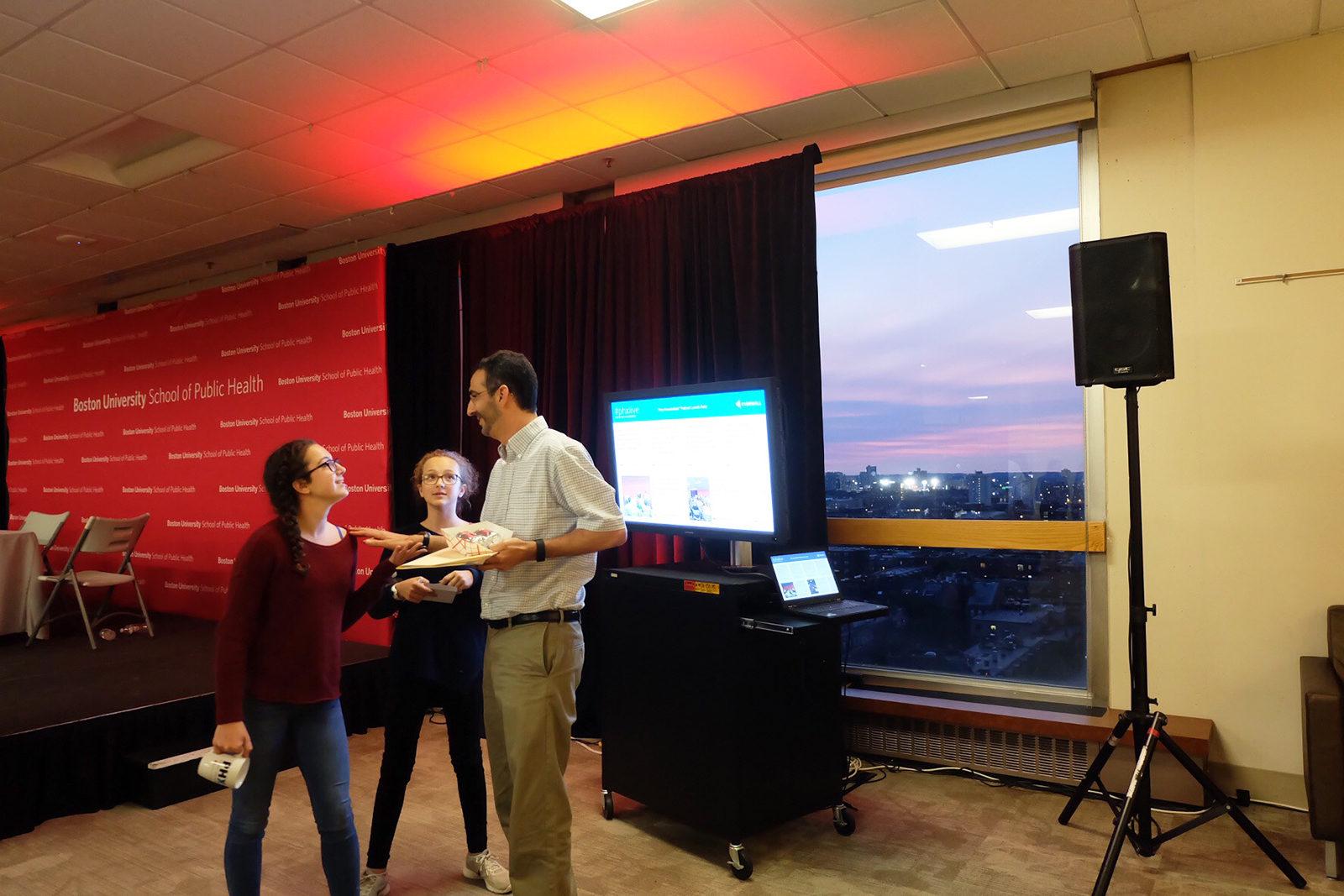 Professor Matthew Fox speaks to his daughters following the School of Public Health's podcast launch for "Free Associations" Tuesday night at the Boston University Hiebert Lounge. PHOTO BY EMILIE LIU/ DAILY FREE PRESS STAFF