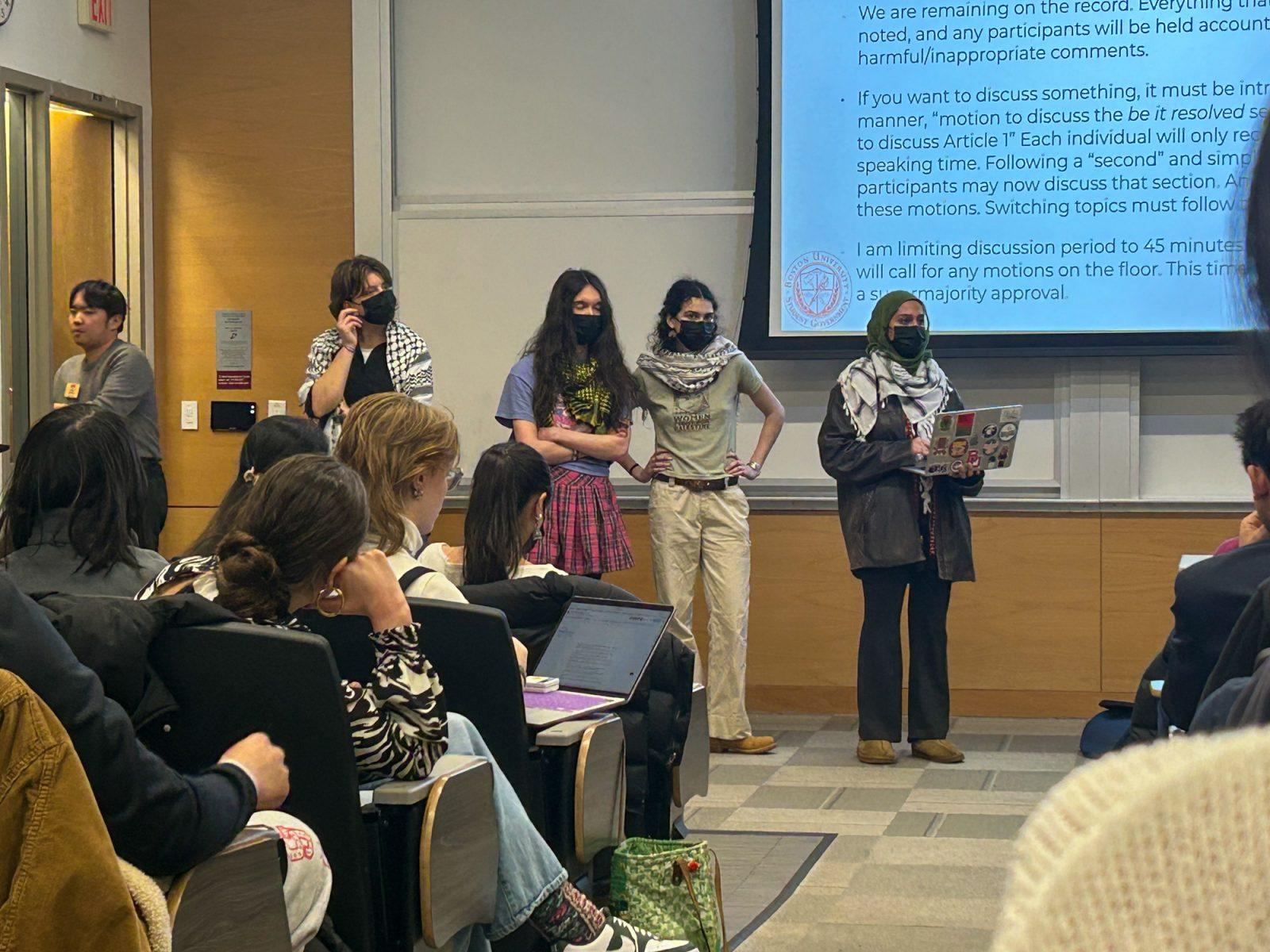 Members of Boston University Students for Justice in Palestine speak at the BU Student Government meeting on Monday. StuGov members passed a bill for the university to disclose investments in companies involved in Middle Eastern conflicts. PHOTO BY HANNAH BAPTISTE 
