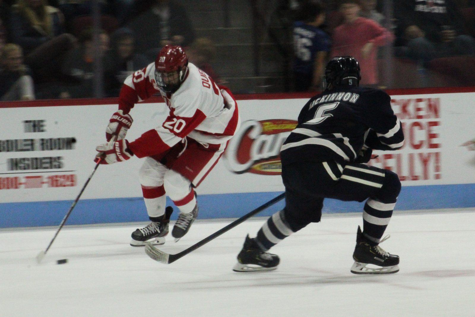 Matt Quercia shields the puck from a Wildcat defenseman in a game against UNH last week. JENNA VANSICKLE/ DAILY FREE PRESS STAFF