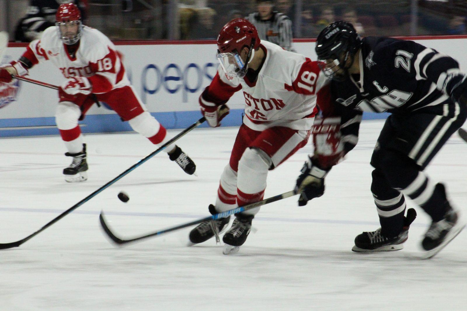 Freshman forward Robert Mastrosimone fends off a Wildcat in last week’s game against UNH. JENNA VANSICKLE/ DAILY FREE PRESS STAFF