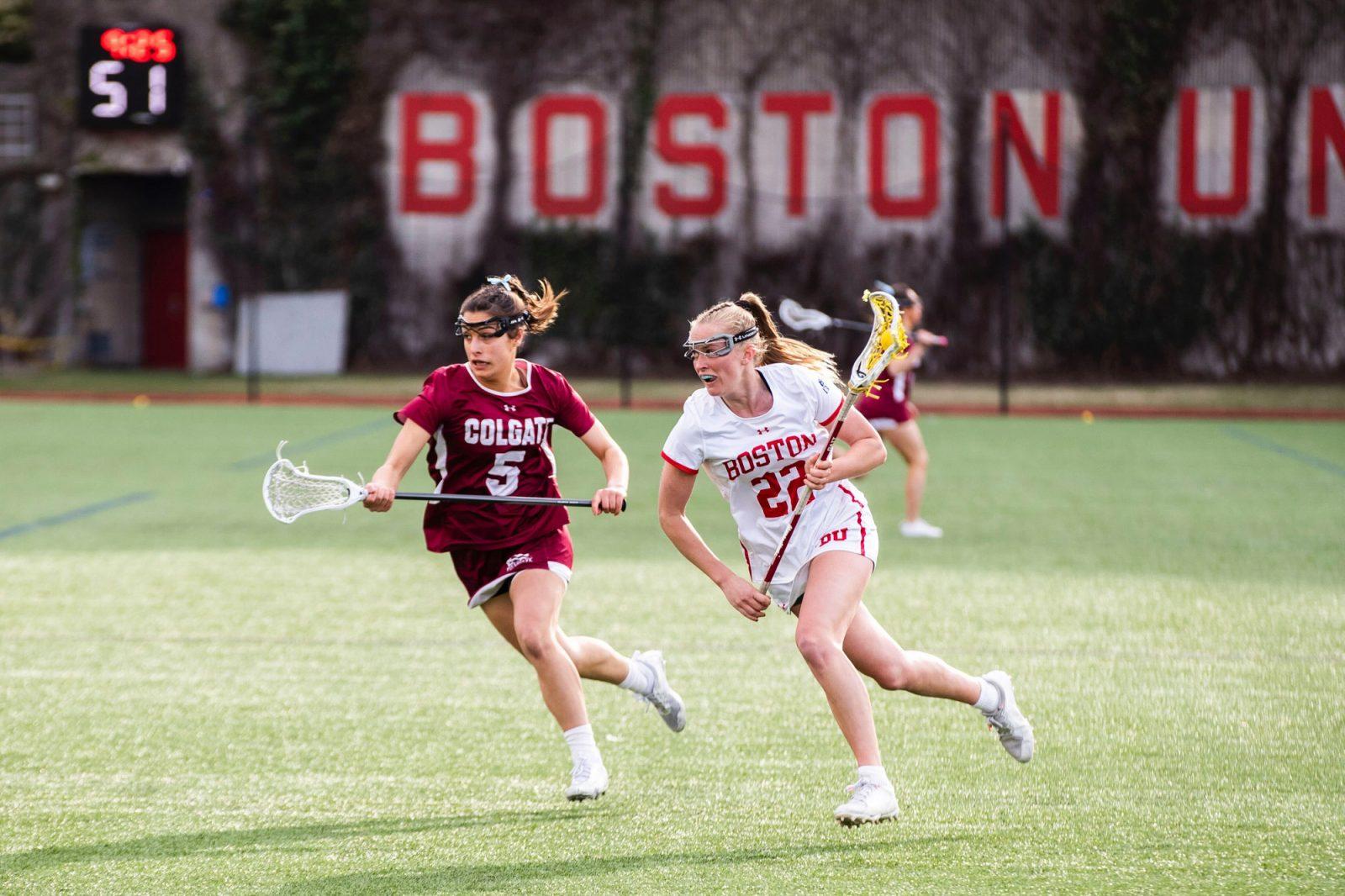 Then-junior midfielder Avery Jones (22) runs with the ball during a game against Colgate University on Apr. 17, 2024. The Boston University women’s lacrosse team opens its season against Boston College on Sunday. COURTESY OF MATT WOOLVERTON/BU ATHLETICS
