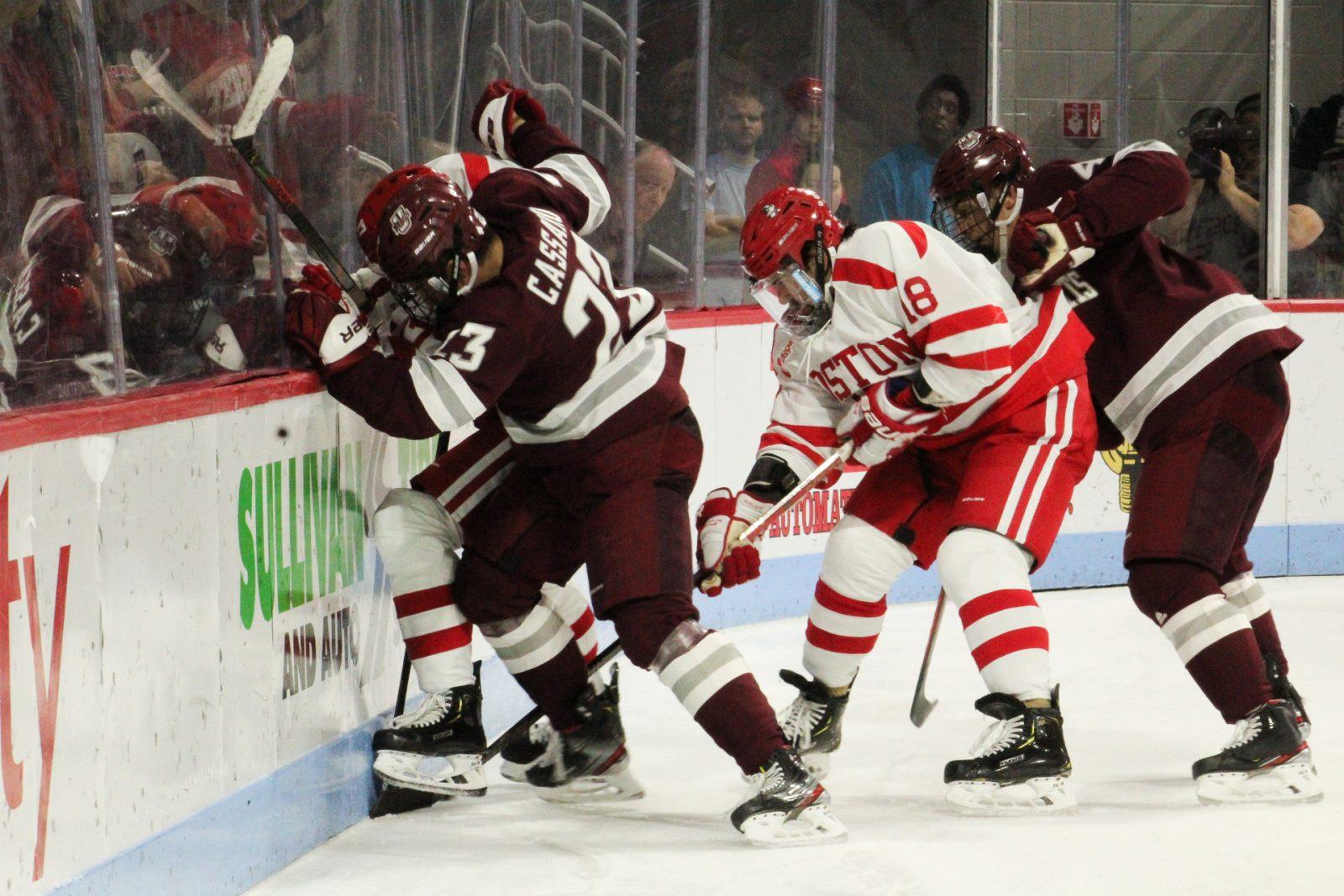 Boston University and the University of Massachusetts Amherst battle for a puck Friday night. JENNA VANSICKLE/ DAILY FREE PRESS STAFF