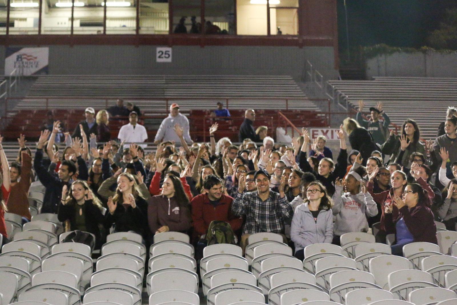 Students in BU's Deaf studies program cheer for the women's soccer team at a game against Harvard University Wednesday night. PHOTO BY BETSEY GOLDWASSER/ DAILY FREE PRESS STAFF