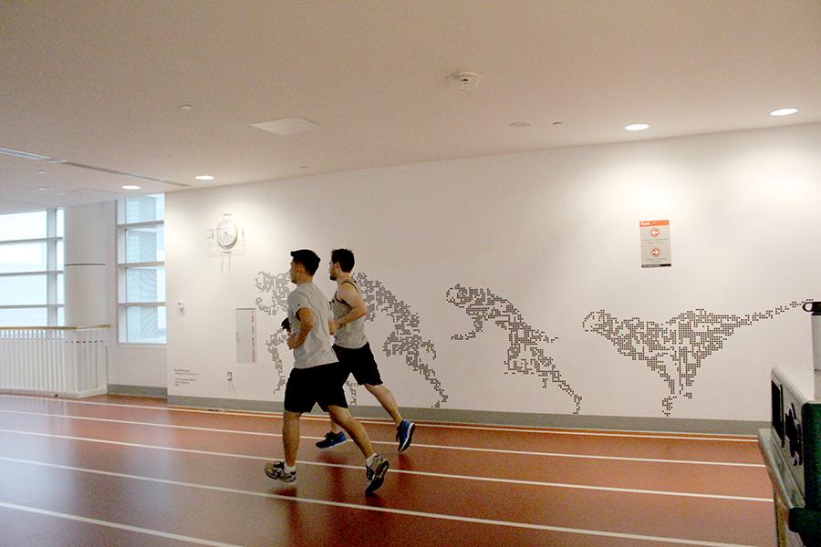 Runners jog around the indoor track in FitRec. BU has offered a marathon training PDP course for students for many years, though the course was not offered this semester. PHOTO BY HANNAH ROGERS/DAILY FREE PRESS STAFF