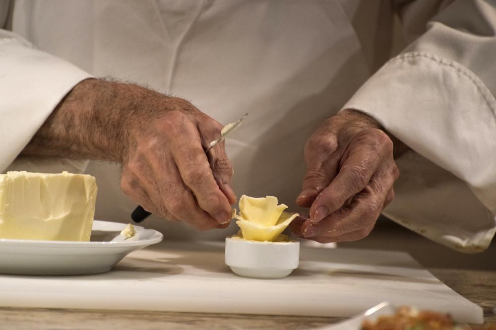 Master chef Jacques Pépin prepares a butter rose during his cooking demonstration and dinner. 
PHOTO BY LEXI PLINE/ DAILY FREE PRESS STAFF 
