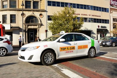 A group of Boston taxi owners is suing Gov. Charlie Baker, saying the new statewide rules for services like Uber and Lyft are unconstitutional. PHOTO BY JESS RICHARDSON/ DAILY FREE PRESS CONTRIBUTOR 
