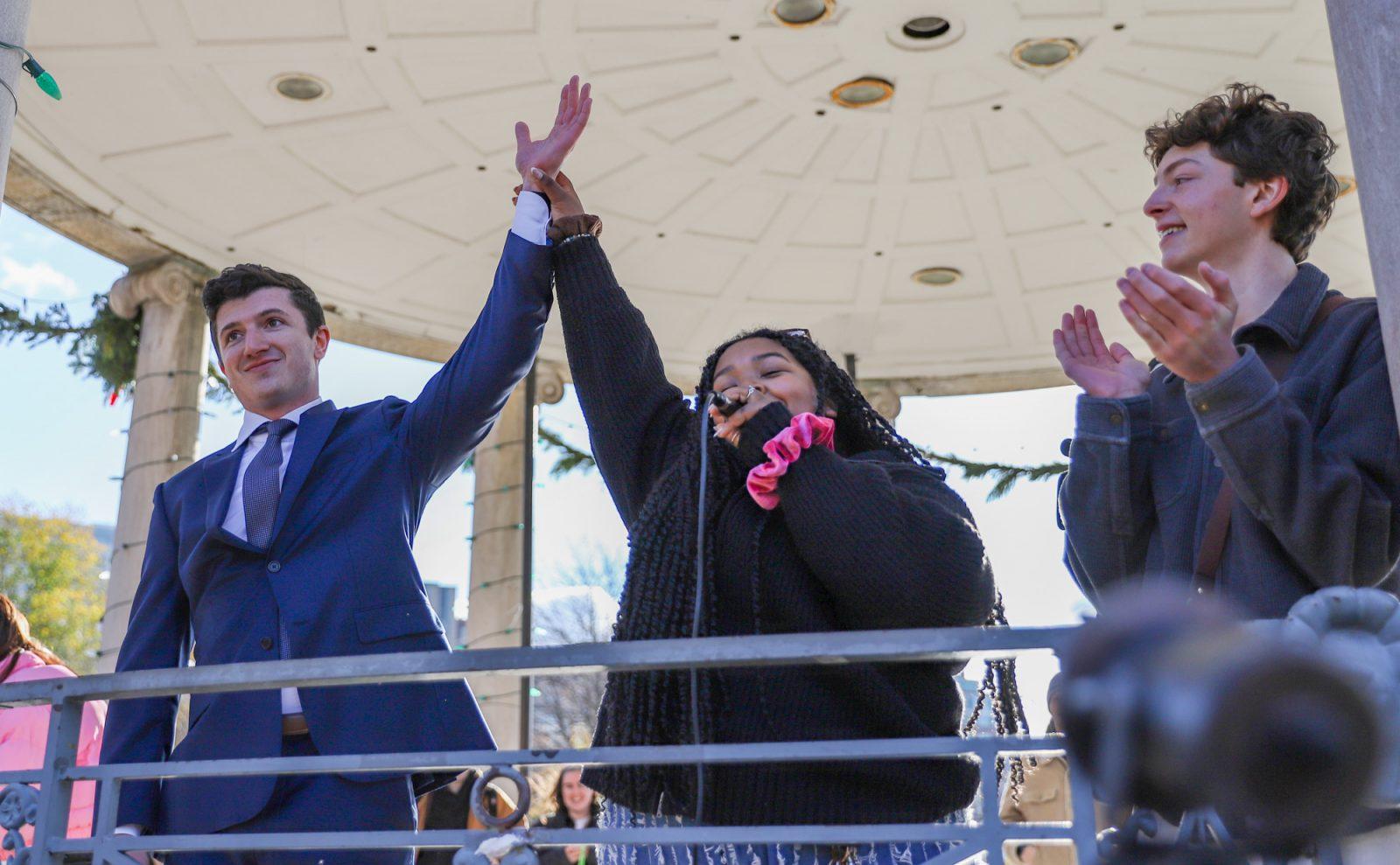 Dilce Oliveira (center), one of the organizers of the Tom Holland look-alike contest, raises Nick Anderson’s (left) hand, announcing him the winner of the contest. Oliveira and Katherine Gehring hosted the Tom Holland look-alike contest Sunday at Boston Common. KATE KOTLYAR/DFP PHOTOGRAPHER
