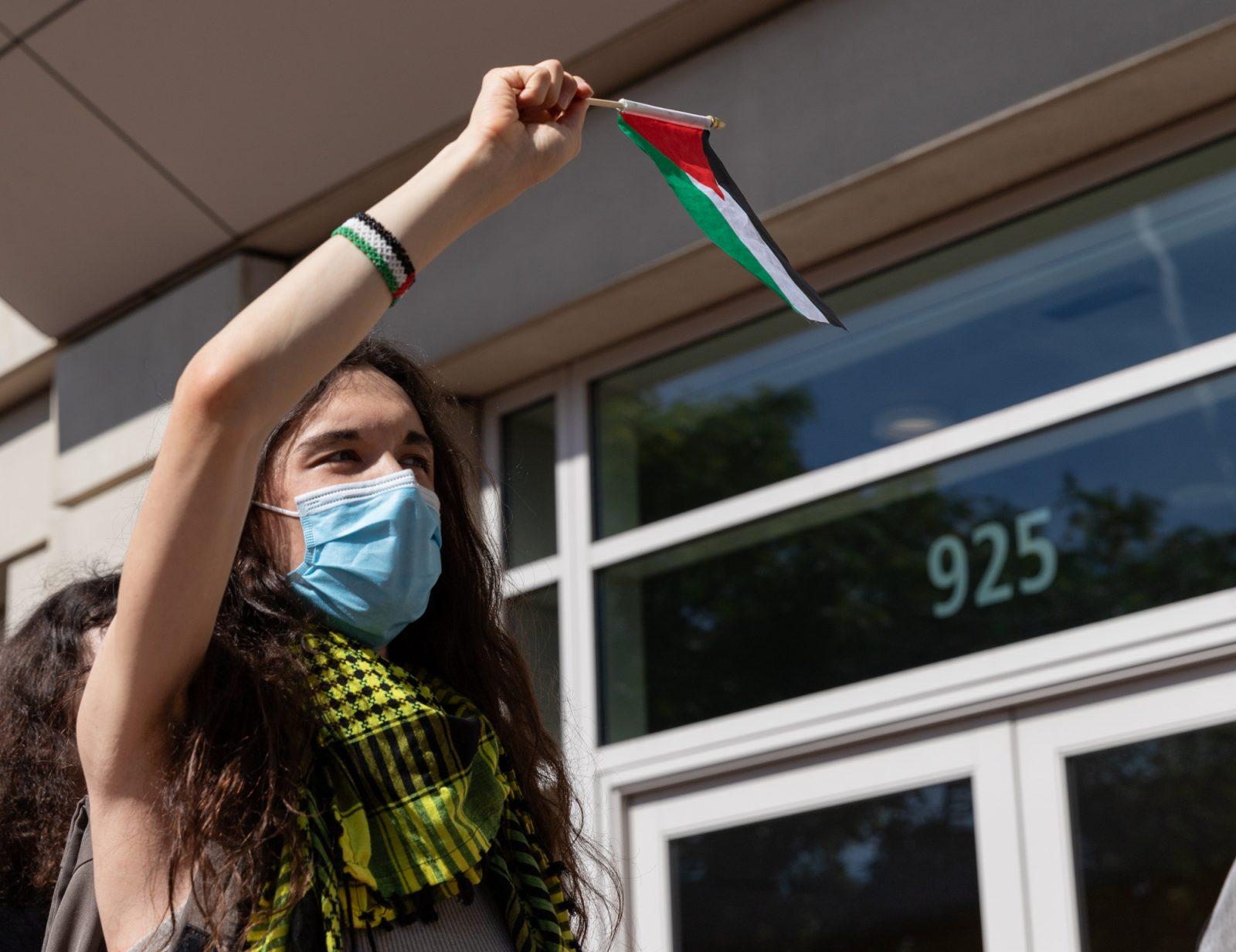 A protester waves a Palestinian flag outside Agganis Arena, where Boston University President Melissa Gilliam’s inauguration took place. Multiple protests by the BU Graduate Workers Union, BU Students for Justice in Palestine, BU Young Democratic Socialists and BU Palestine Liberation Coalition occurred around campus during the inauguration. KATE KOTLYAR/DFP PHOTOGRAPHER