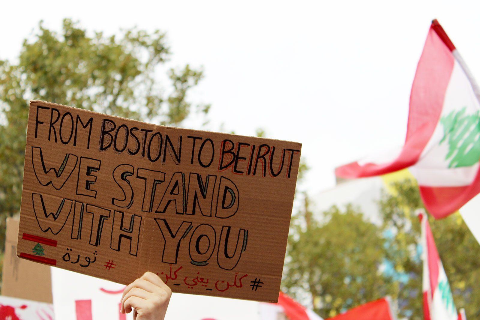 A protester holds up a sign in a show of solidarity with protestors in Lebanon at a Sunday rally in Copley Square, part of a global response to corruption in the Lebanese government. MIA KHATIB/ DAILY FREE PRESS STAFF