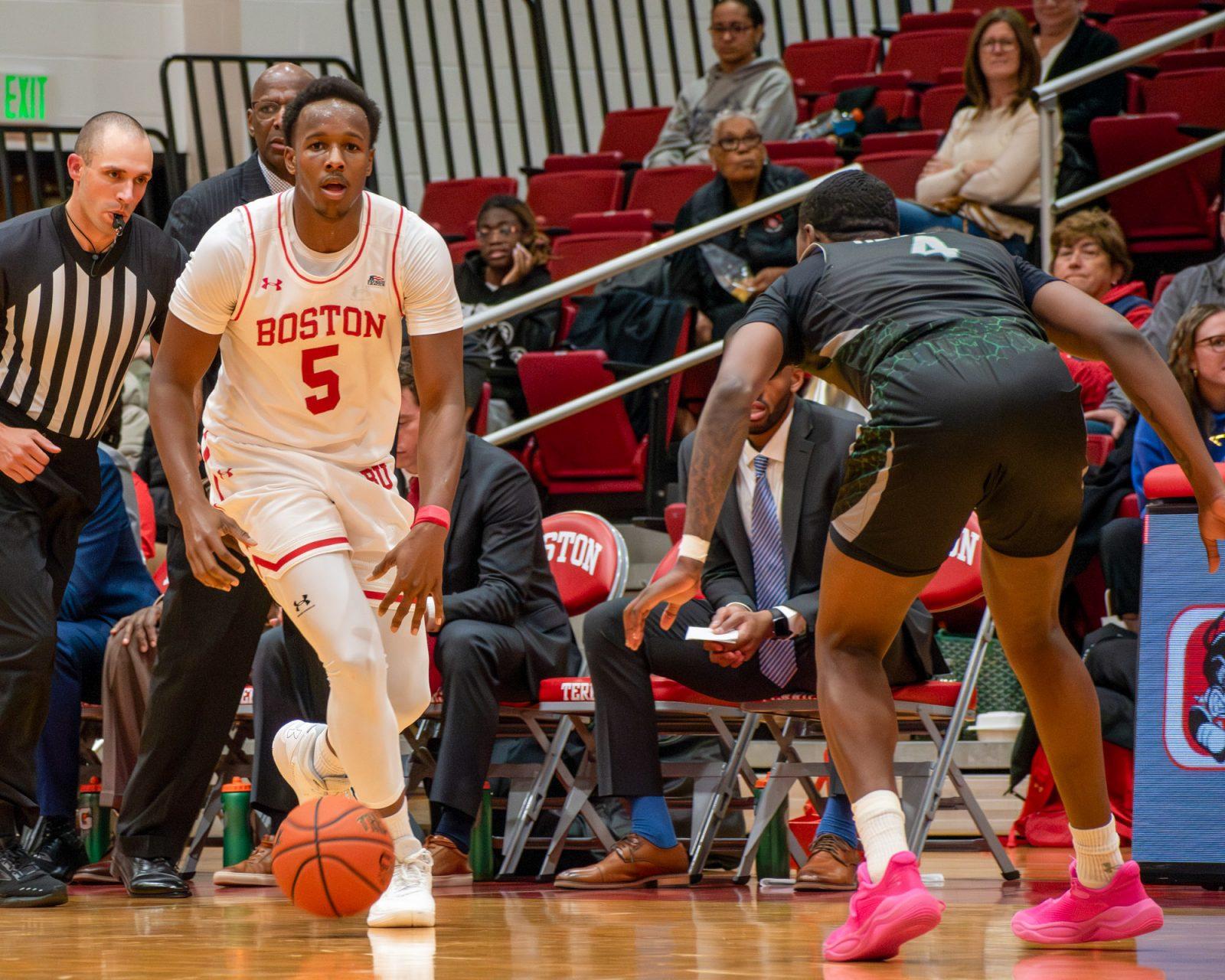 Sophomore guard Kyrone Alexander (5) dribbles the ball during a game against Wagner College on Nov. 19, 2024. The Boston University men’s basketball team lost by two points to Loyola University Maryland on Saturday. JOHN DOWNES/DFP PHOTOGRAPHER 

