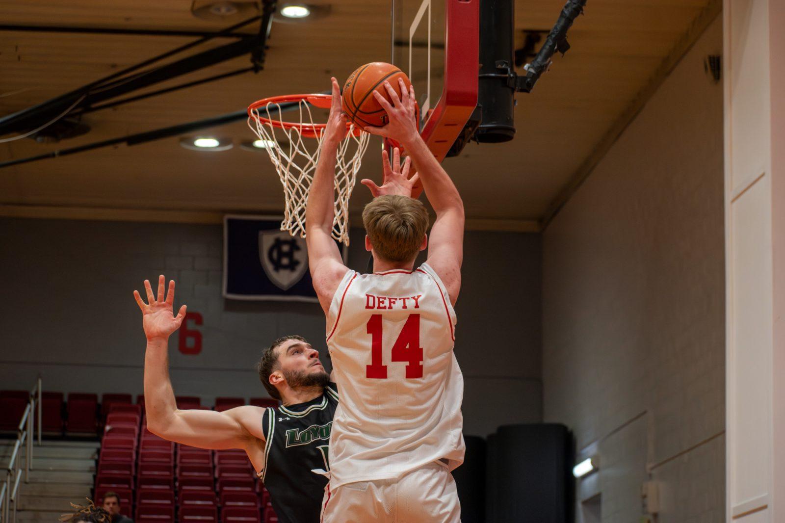 Freshman forward Ben Defty (14) shoots the ball during a game against Loyola Maryland Feb. 19. The Boston University men’s basketball team came out victorious 79-68 against Lehigh University on Wednesday. JOHN DOWNES/DFP PHOTOGRAPHER  