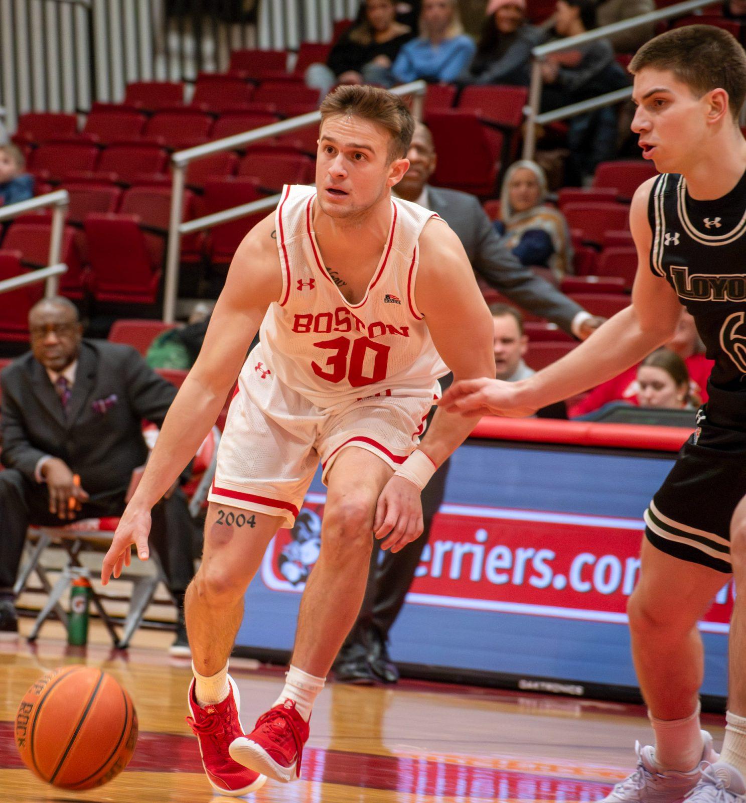 Junior Guard Ben Roy (30) dribbles the ball during a home game against Loyola on Wednesday. Boston University’s men’s basketball team won 68-66 after a tight 69-67 loss in their first matchup this season. JOHN DOWNES/DFP PHOTOGRAPHER  