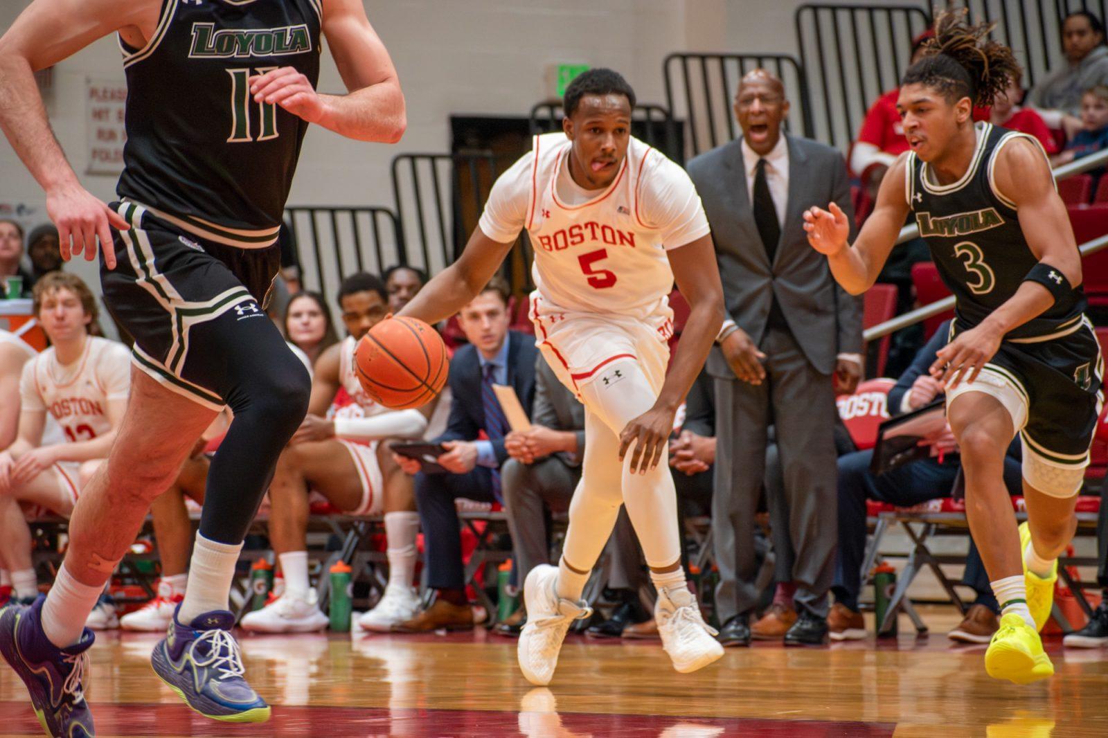 Sophomore guard Kyrone Alexander (5) dribbles the ball during a game against Loyola Maryland Feb. 19. The Boston University men’s basketball team fell to American University in Washington, D.C. on Saturday. JOHN DOWNES/DFP PHOTOGRAPHER 
