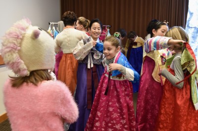 After watching a demonstration of traditional bowing and greeting, a group of young girls try on traditional Korean dresses at the free Lunar New Year Celebration at the Museum of Fine Arts Saturday afternoon. PHOTO BY MADDIE MALHOTRA/DAILY FREE PRESS STAFF 