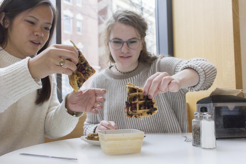 E-Beth Leach and Sophie Perez try a waffle they created for BU Food Engineers. PHOTO BY VIVIAN MYRON/ DAILY FREE PRESS STAFF

