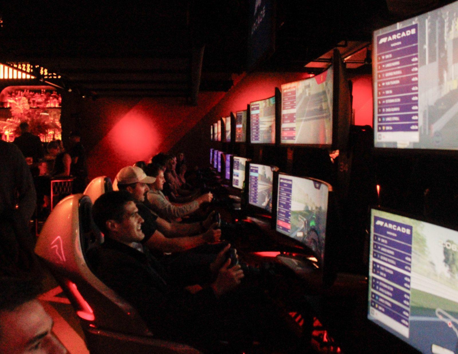 People race in a game at an F1 Arcade in Seaport. This F1 Arcade is the first one to open in the United States, and it drew a large crowd, proving the support for F1 sports in Boston. TRUMAN DICKERSON/DFP PHOTOGRAPHER