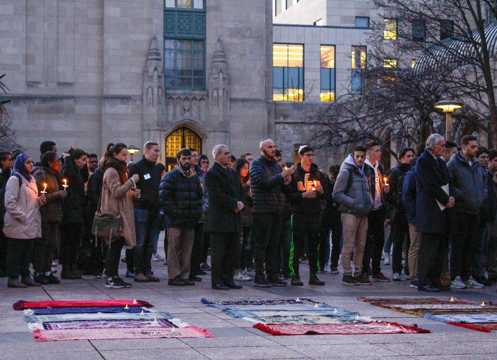 People gather on Marsh Plaza Monday night at a vigil for victims of the terrorist attack in New Zealand. RACHEL SHARPLES/ DFP STAFF