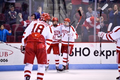 Jordan Greenway (foreground) and Charlie McAvoy (right) celebrate Jakob Forsbacka Karlsson's game-winning goal against UMass. PHOTO BY SOFI LAURITO/DAILY FREE PRESS STAFF