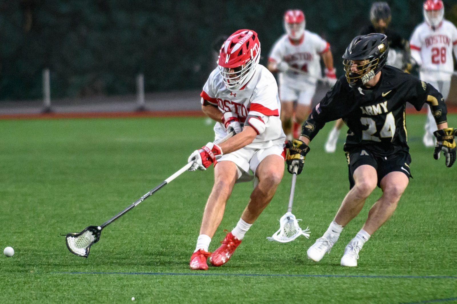 Then graduate student Patrick Morrison (77) and an Army West Point player chase after the ball during a game on March 22, 2024. The Boston University men’s lacrosse team beat Brown University at Nickerson Field on Tuesday. ANDREW BURKE-STEVENSON/DFP PHOTOGRAPHER
