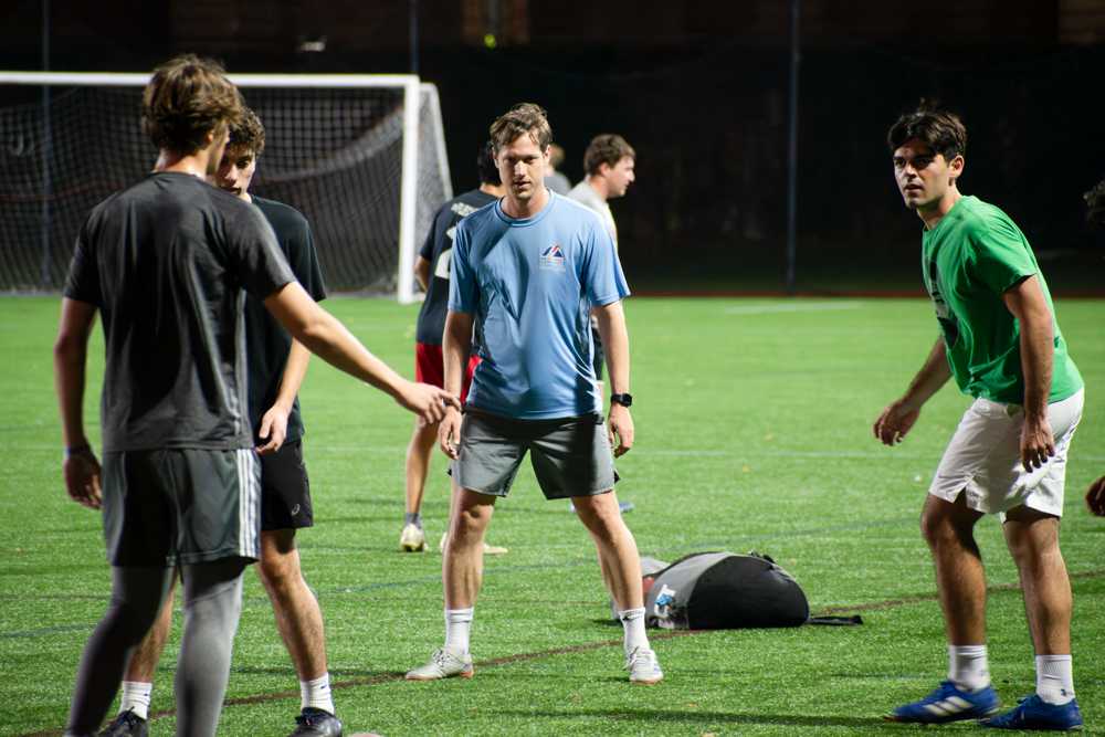 Head coach David Byrd and members of the Boston University’s men soccer club at a practice on Nov. 6. The club has 27 players and is 1st in their division, despite ranking 13th overall in goals scored. JOHN DOWNES/DFP PHOTOGRAPHER. 