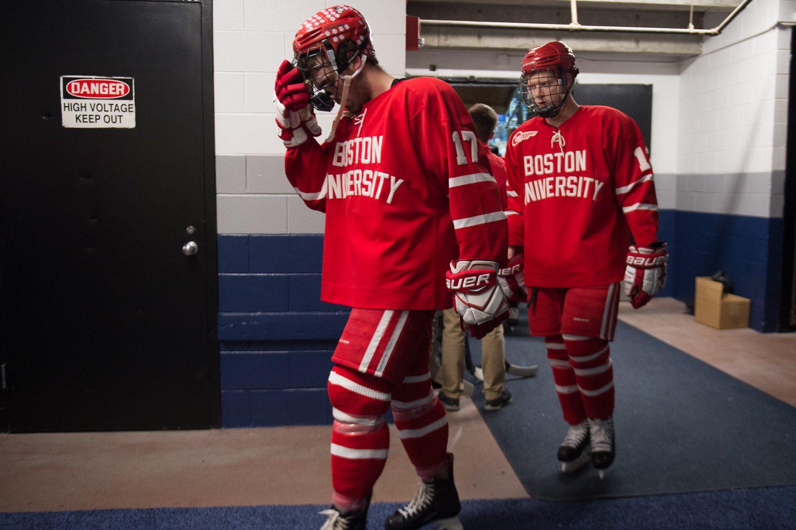 Sophomore defenseman Dante Fabbro and senior forward Chase Phelps coming off the ice following BU's loss to Michigan in the NCAA Northeast Regional final Sunday night at the DCU Center.