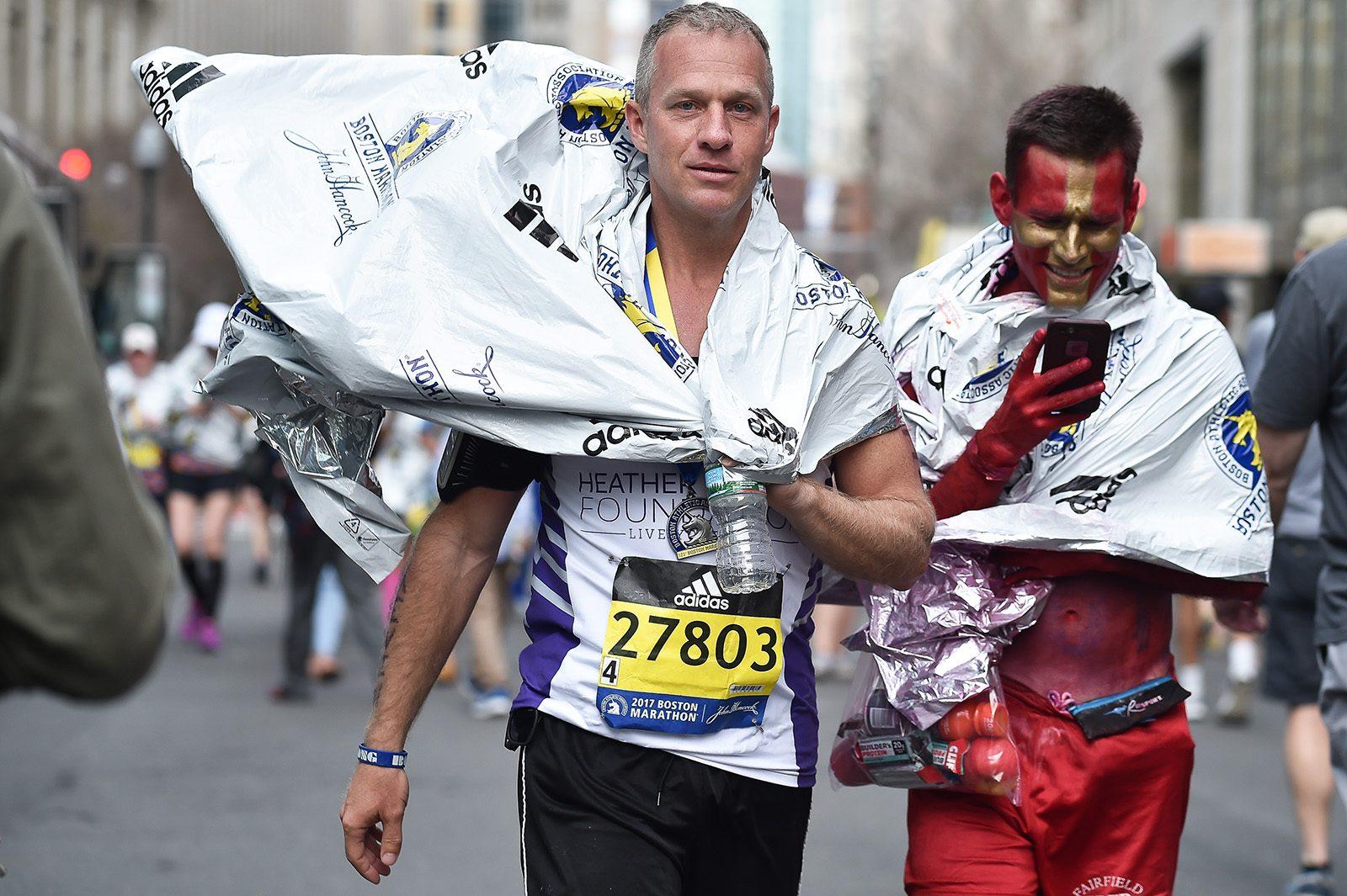 Kevin Krueger, of Florida, wears a blanket as he rests after the race. PHOTO BY MADDIE MALHOTRA/ DAILY FREE PRESS STAFF