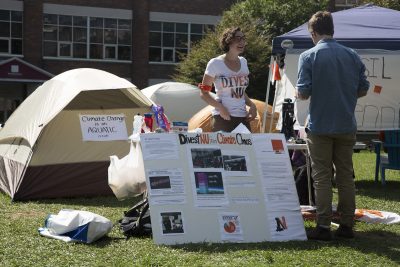 Alissa Zimmer, a member of DivestNU, talks with a fellow student about what the organization is doing to protest the university. PHOTO BY NATALIE CARROLL/DAILY FREE PRESS CONTRIBUTOR