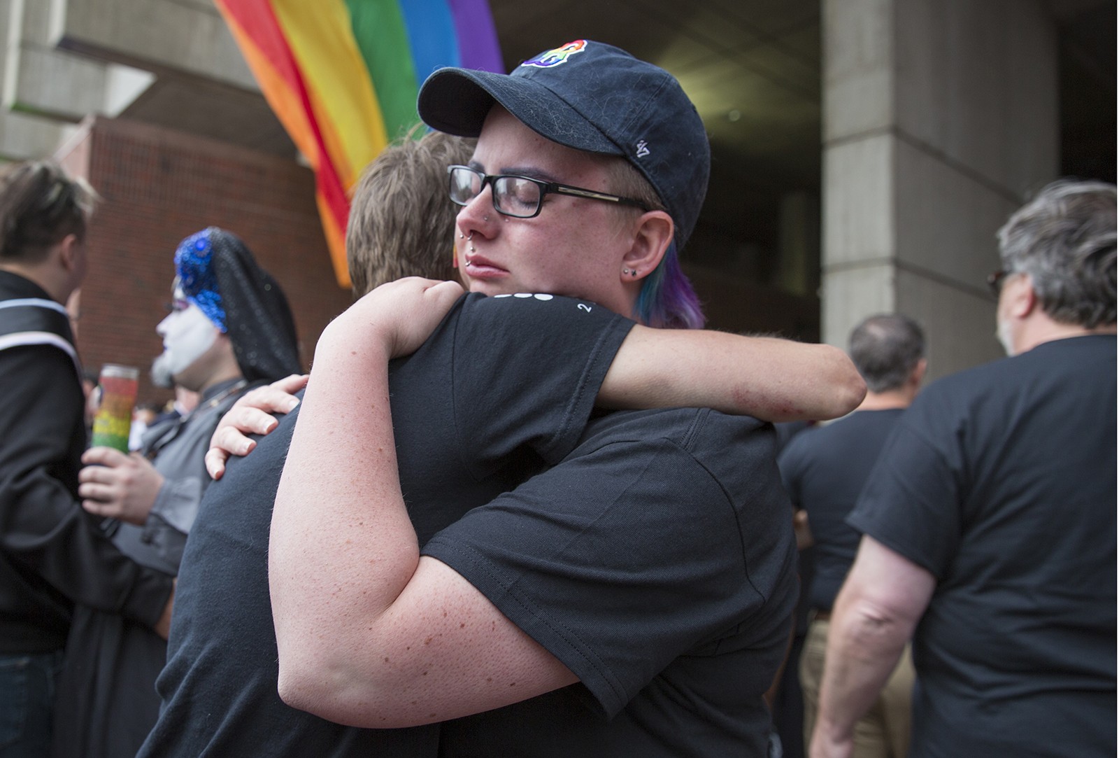 Amidst hundreds of other supporters, members of a Boston Pride group hug at City Hall Monday evening. PHOTO BY SARAH SILBIGER/ DAILY FREE PRESS STAFF