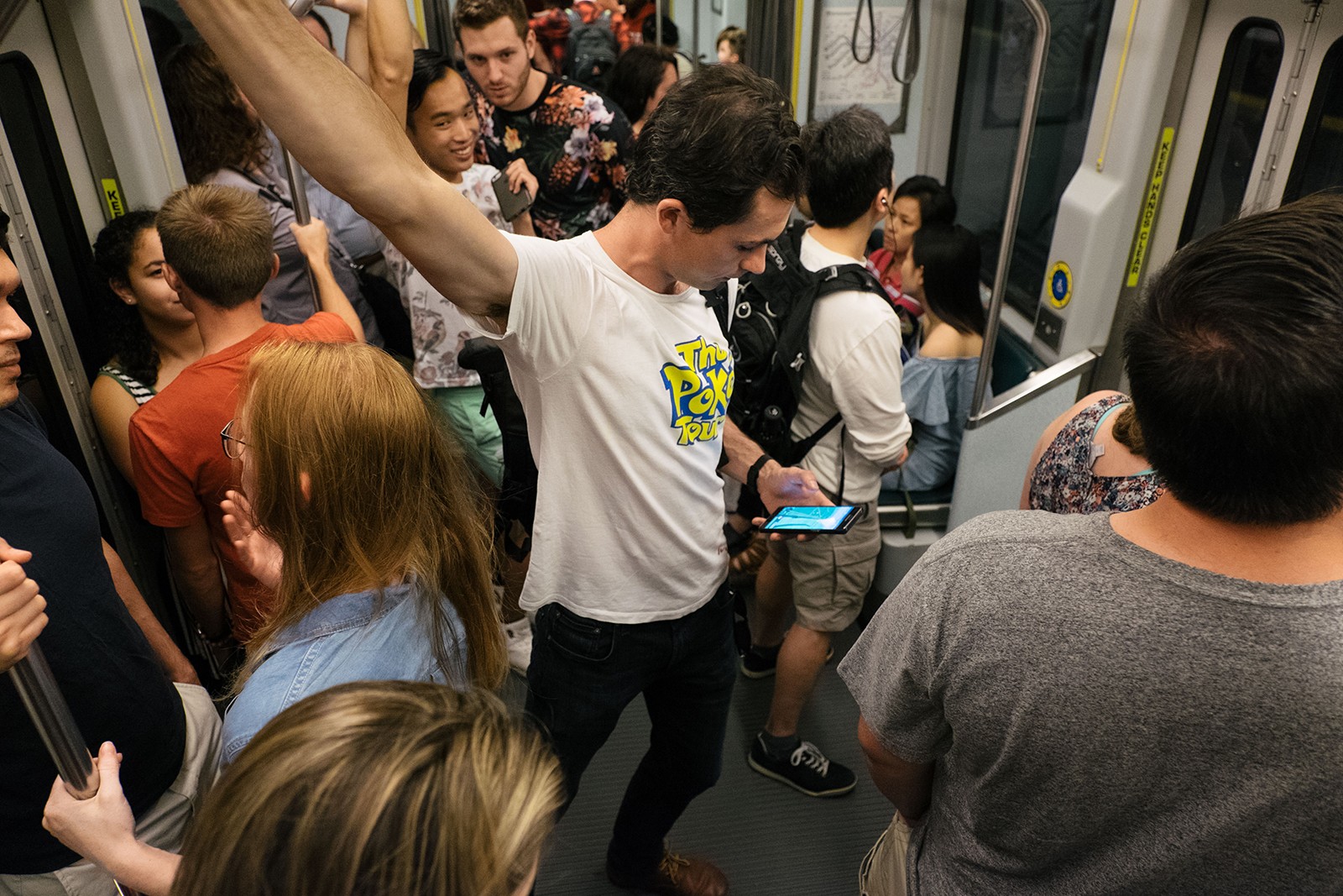"Poke Tour" coordinator Adam Wallek looks at a map to catch Pokemon while riding the T. PHOTO BY BRIAN SONG/ DAILY FREE PRESS STAFF 