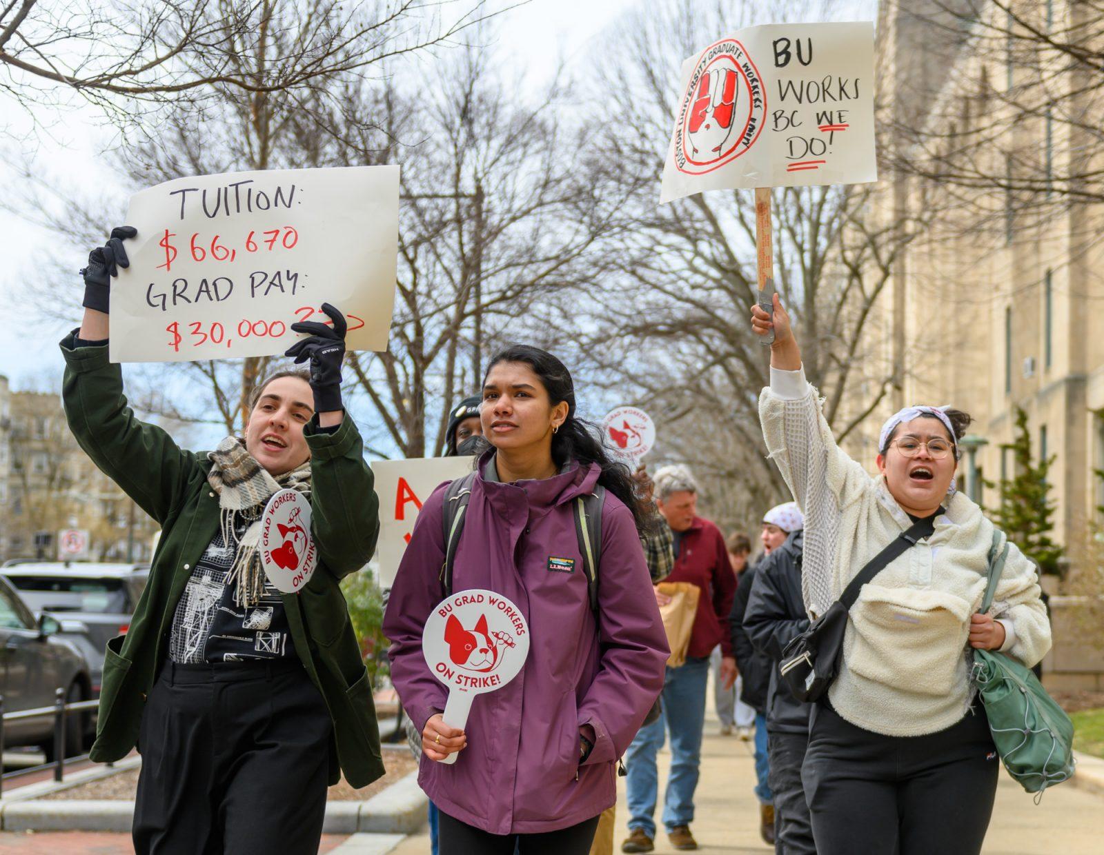 Members of the Boston University Graduate Workers Union march from Marsh Plaza to the Center for Computing and Data Science on March 25. BU’s Office of the Provost updated its payroll policy to withhold compensation from striking employees. MOLLY POTTER/DFP PHOTOGRAPHER