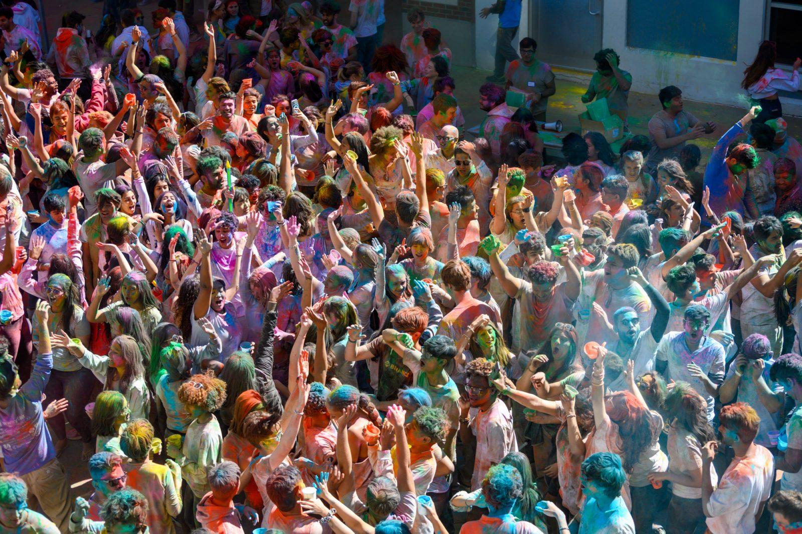 Holi participants dance to music and throw colored powder in the air at the festival on Cummington Mall. MOLLY POTTER/DFP PHOTOGRAPHER