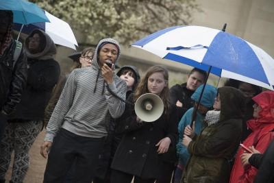 Despite rain and cold weather, protestors gather in Marsh Plaza to speak out against the neo-Nazi posters and placards pasted around campus over the weekend. PHOTO BY LEXI PLINE/ DAILY FREE PRESS STAFF 