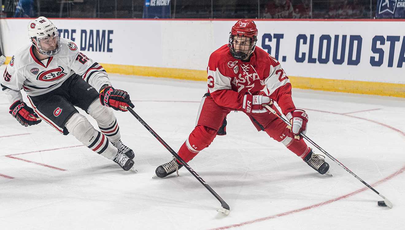 defenseman domenick fensore takes the puck up the ice