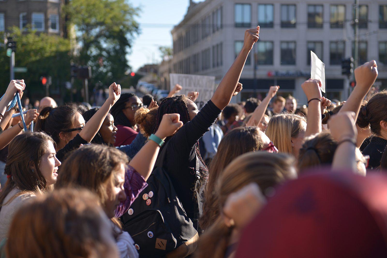 The crowd yells "together we unite" at the walk-out for Black Lives Matter Thursday afternoon in Marsh Plaza. PHOTO BY SHANE FU/ DAILY FREE PRESS STAFF 