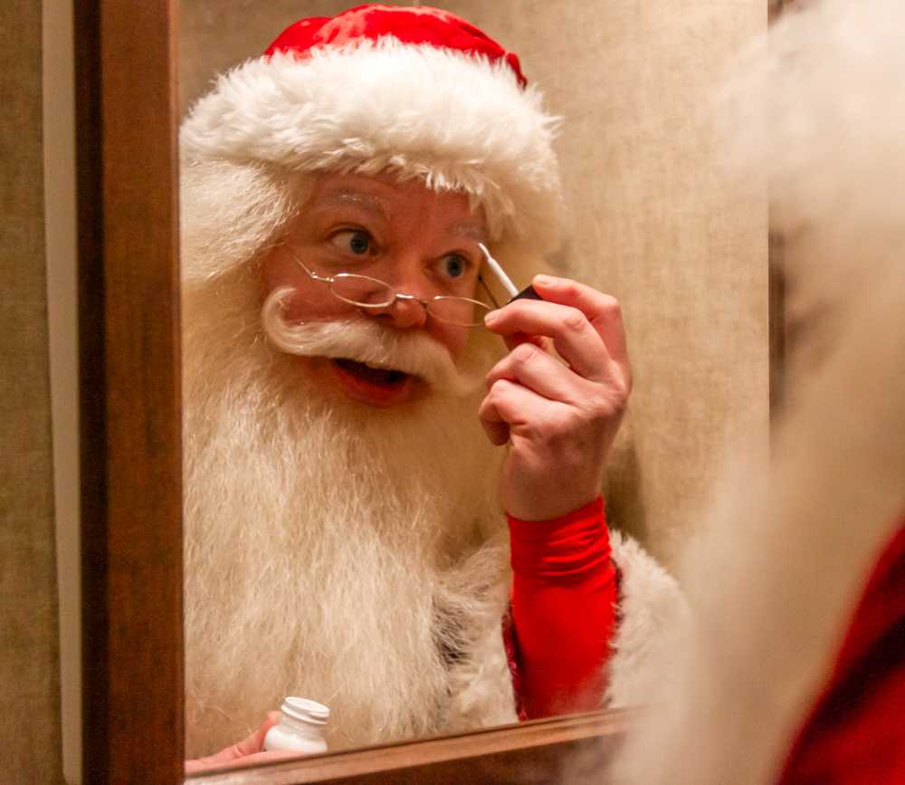 Boston’s official Santa Claus Jim Manning paints his eyebrows white to prepare for his 12th annual performance at the 2023 Boston Common Tree Lighting. MARGARET CORONA/DFP STAFF