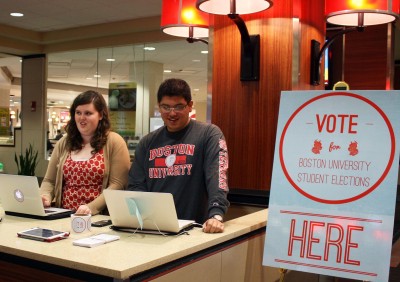 Jaimie Dingus (CAS ’16) and Michael Munoz (ENG '16) work a table in the George Sherman Union Monday, encouraging students to vote in Student Government elections. PHOTO BY BETSEY GOLDWASSER/DAILY FREE PRESS STAFF