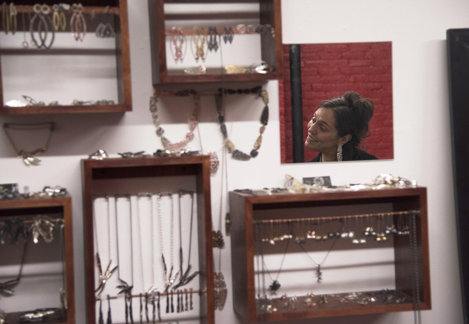 Amy Casher, a local jewelry maker, speaks to attendees of a SoWa First Friday event put on by the SoWa Artists Guild in the "South of Washington" area. PHOTO BY LEXI PLINE/DAILY FREE PRESS STAFF