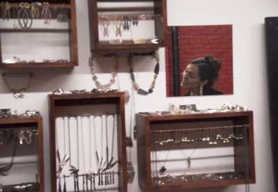 Amy Carter, a local jewelry maker, speaks to attendees of a SoWa First Friday event put on by the SoWa Artists Guild in the "South of Washington" area. PHOTO BY LEXI PLINE/DAILY FREE PRESS STAFF