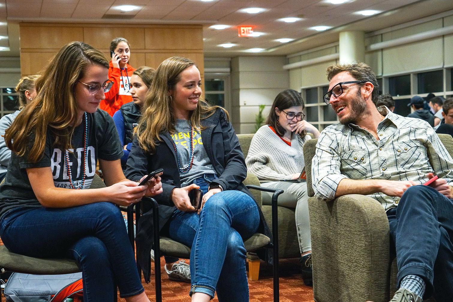 Boston University political science professor Dino Christenson (right) chats with students at a watch party Tuesday night at Student Village 1. SERENA YU/ DAILY FREE PRESS STAFF