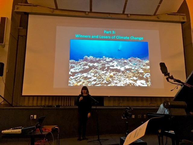 Boston University Assistant Professor of Biology Sarah Davies speaks at the “Music of Reality: Reef Music” event, an interdisciplinary concert inspired by her research. COURTESY OF LESLIE KAUFMAN