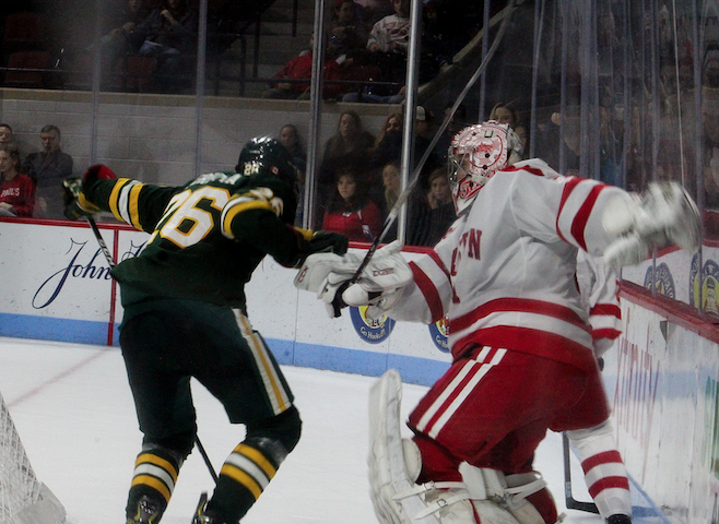 Sam Tucker tangles with a Catamount behind the Boston University net. JENNA VANSICKLE/ DAILY FREE PRESS STAFF
