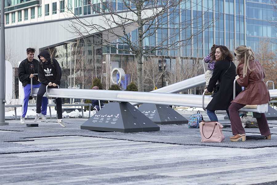 People play on the Seaport seesaws on the Seaport Common both during the day. PHOTO BY MALAIKA MOYER/ DAILY FREE PRESS STAFF