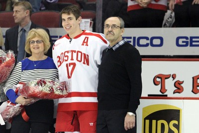 Evan Rodrigues (center) poses with his parents Christine (left) and Norbert during the Senior Night ceremony prior to Friday's game. PHOTO BY MAYA DEVEREAUX/DAILY FREE PRESS STAFF