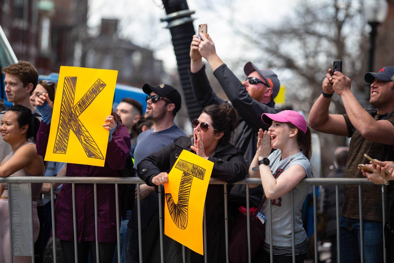 Fans cheering on their friends or family members participating in the Boston Marathon by holding up big orange signs with letters on them.
SOPHIE PARK/ DFP STAFF