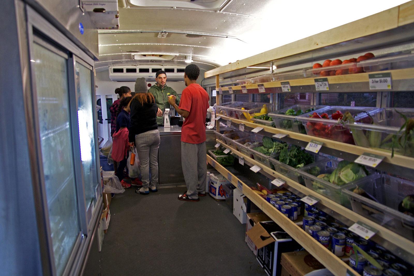 Fresh Truck, a renovated school bus filled with fresh produce, provides healthy food alternatives for residents living in food desert neighborhoods. PHOTO BY SYDNEY MAES/ DAILY FREE PRESS STAFF