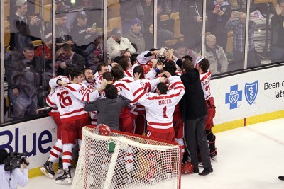 The Terriers swarm goaltender Matt O'Connor following their win over Lowell. PHOTO BY MAYA DEVEREAUX/DAILY FREE PRESS