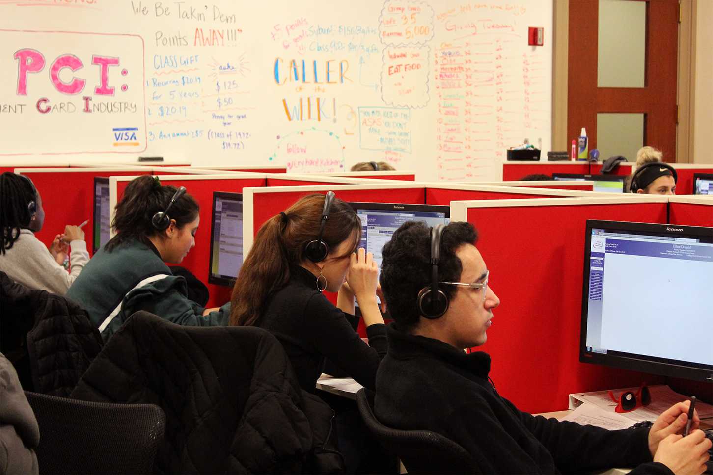 Students make calls on #GivingTuesday at the Boston University Telefund, located on the seventh floor of the Questrom School of Business. RACHEL SHARPLES/ DAILY FREE PRESS STAFF