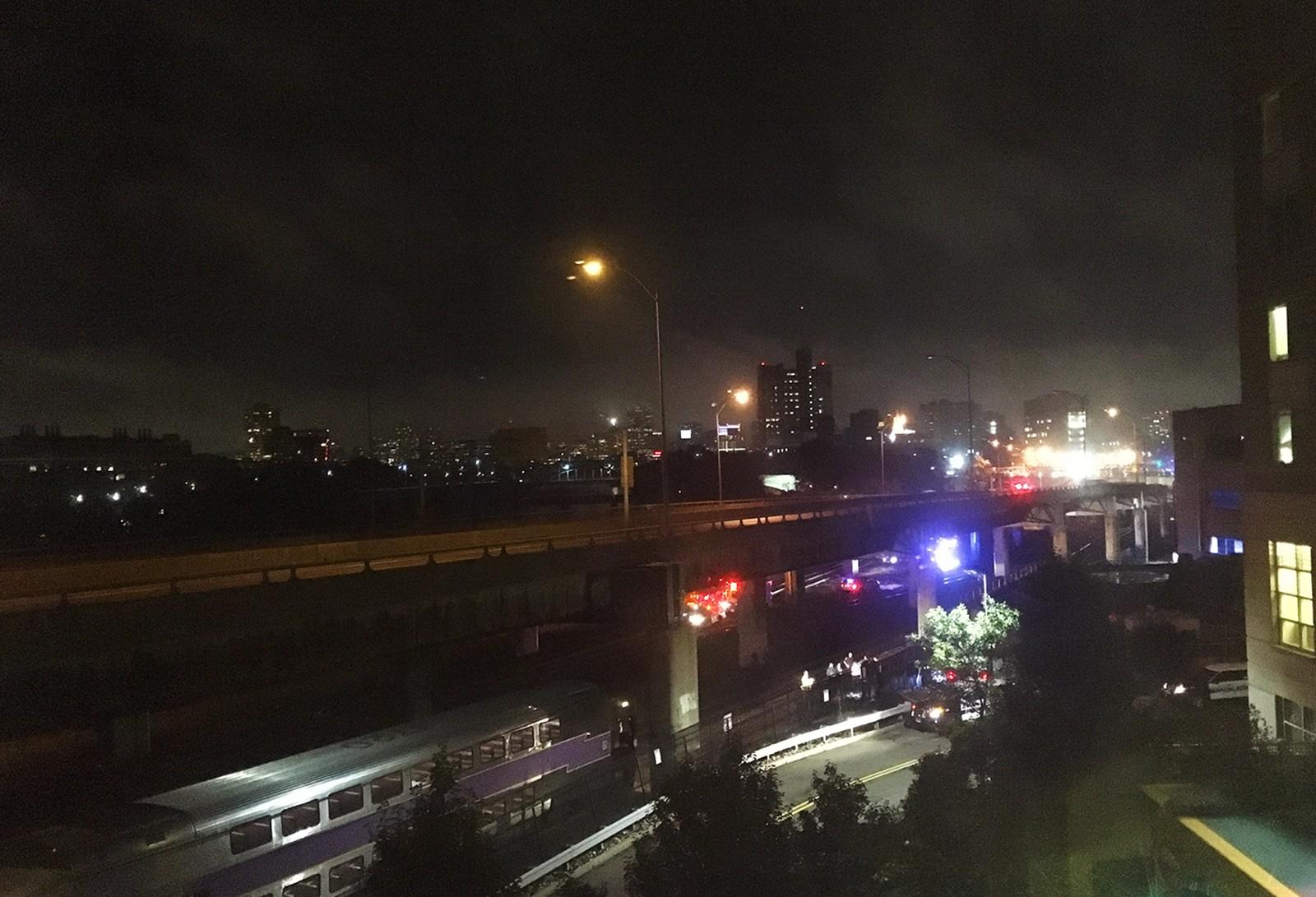 Crews investigate the tracks behind 10 Buick St. early Wednesday morning.